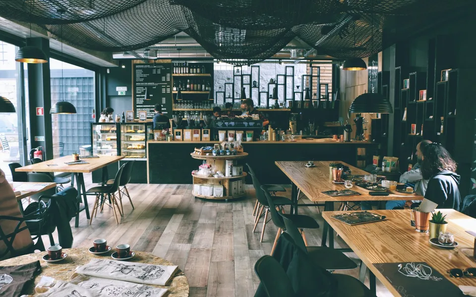 Inside the Brew & Bloom café, plants and warm timber