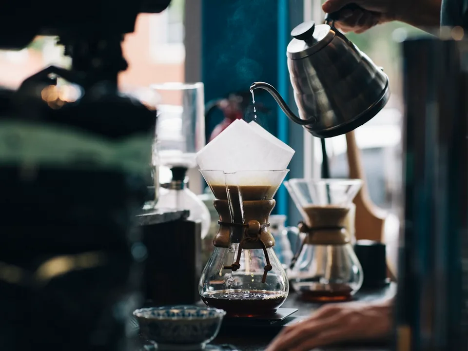 Barista brewing a V60 pour over by hand