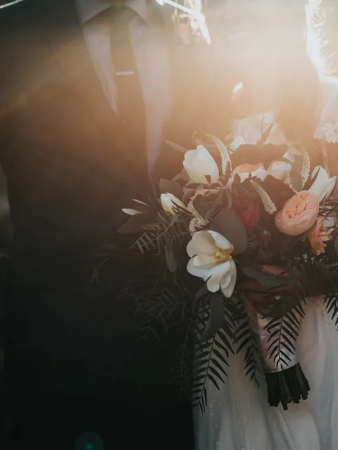 The bouquet, held in golden evening light